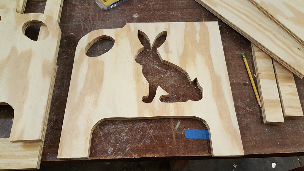 an unfinished piece of wood with a bunny shaped cutout